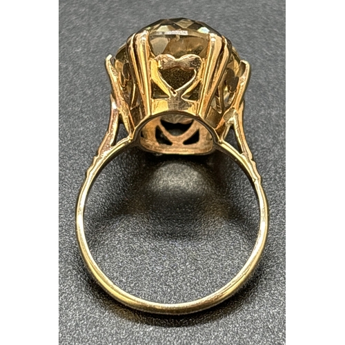 1113 - A 9ct gold large oval cut pale yellow citrine cocktail ring. Double prong set in a raised mount with... 