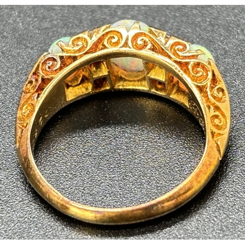 1114 - An Edwardian 18ct yellow gold opal and diamond ring. 3 oval cut opals and 4 small round cut diamonds... 