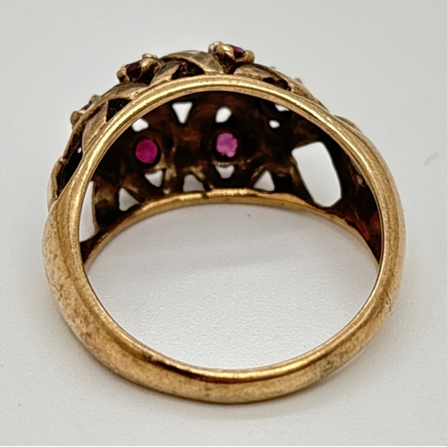 1001 - A vintage 9ct gold dome style ring with lattice work design set with 7 small round cut rubies. Hallm... 