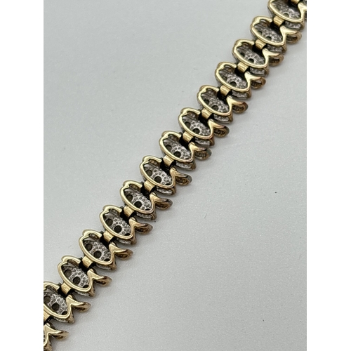 1015 - A 9ct gold and diamond 8 inch bracelet in need of repair. Each link comprises S design yellow gold a... 