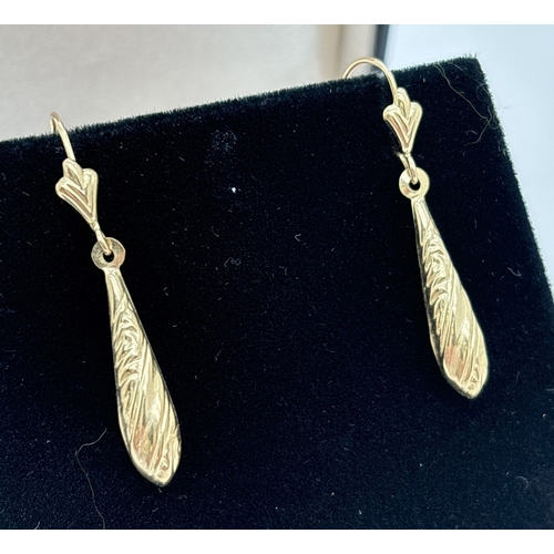 1024 - A pair of yellow gold teardrop earrings with embossed decoration and fleur de lis detail to posts. N... 