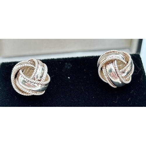 1029 - 3 pairs of silver stud style earrings. A pair of Tudor rose earrings, a pair of large knot style ear... 