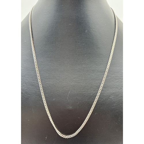 1031 - A 20 inch silver curb chain necklace with spring ring clasp. Silver marks to clasp and fixings. Weig... 