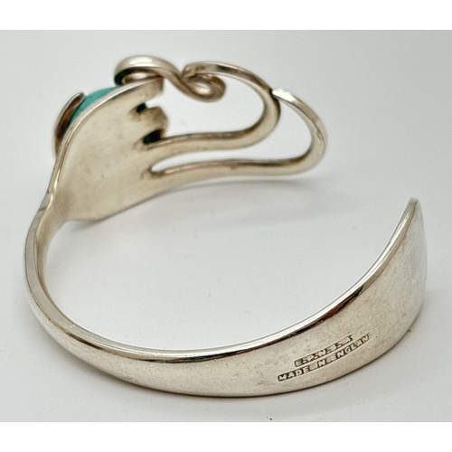 1036 - An unusual costume jewellery open design bangle made from a vintage silver plated fork and set with ... 