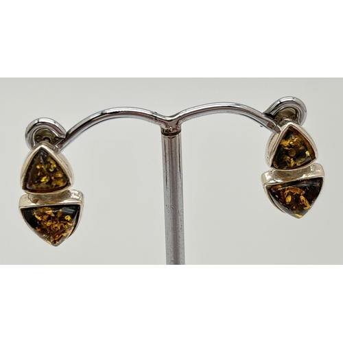 1039 - 3 pieces of green amber and silver jewellery. A heart shaped pendant, a pair of circular stud earrin... 