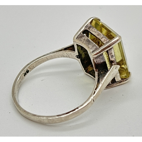 1041 - An Art Deco style vintage silver dress ring set with a large emerald cut pale yellow citrine. Stone ... 