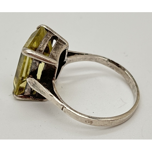 1041 - An Art Deco style vintage silver dress ring set with a large emerald cut pale yellow citrine. Stone ... 