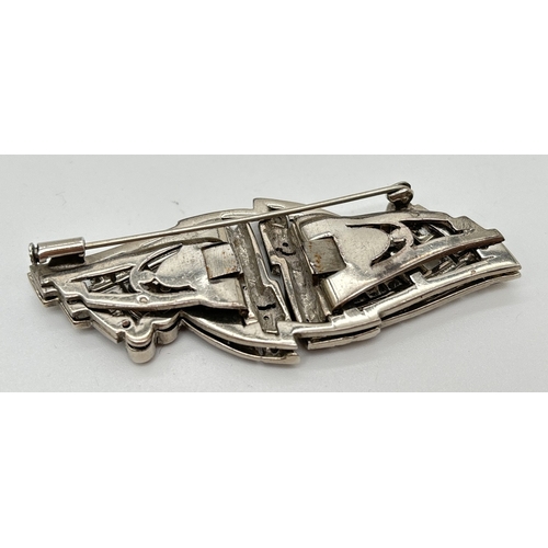 1044 - An art Deco French silver brooch/dress clip in the shape of a bow, set with multiple round cut clear... 