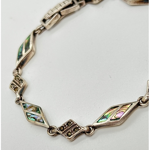 1046 - A 7.5 inch silver, abalone shell and marcasite set diamond shaped link bracelet with clip clasp. Sil... 