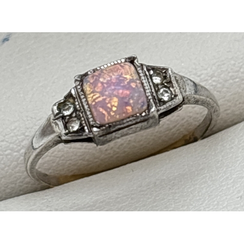 1050 - An Art Deco 9ct gold on silver ring set with a square cut opal paste with 2 small clear stones eithe... 