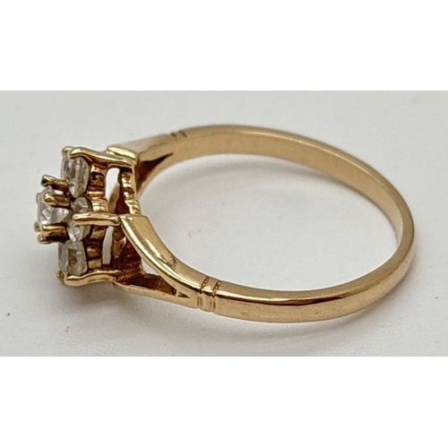 1051 - A vintage 9ct gold cluster ring set with 7 small round cut clear stones. Full hallmarks inside band.... 