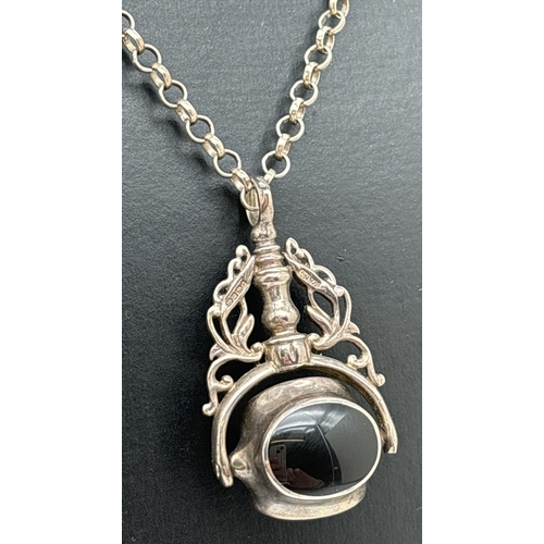 1052 - A silver spinning fob pendant set with mother of pearl, sodalite and black onyx, on an 18