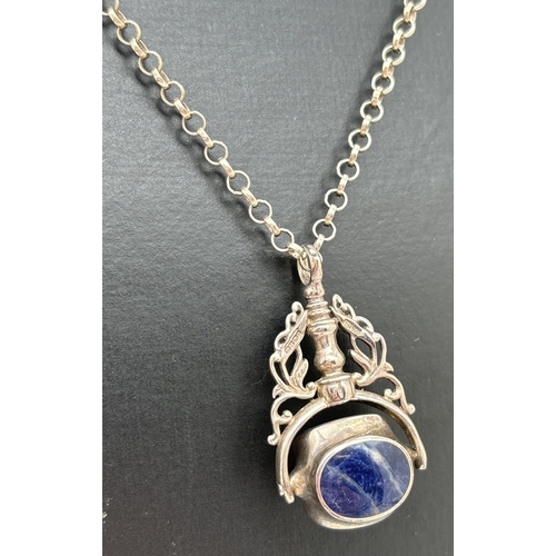 1052 - A silver spinning fob pendant set with mother of pearl, sodalite and black onyx, on an 18