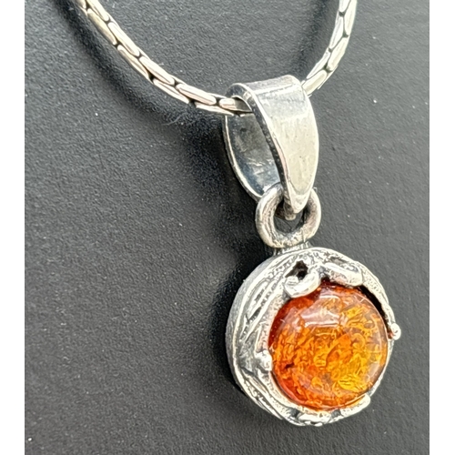 1062 - 2 amber set pendant necklaces. A white metal cat pendant set with cognac amber, on a silver 16