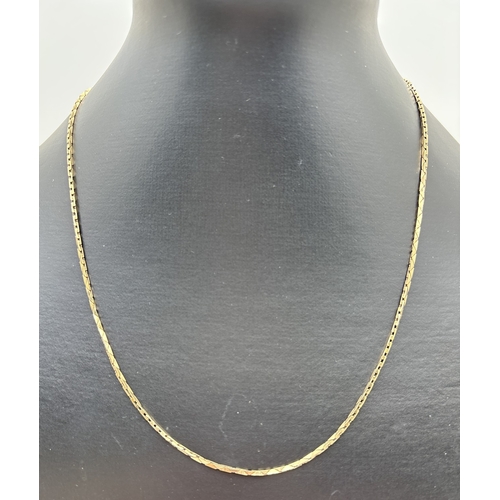 1063 - A 9ct gold 18 inch triangular flat link chain necklace with spring ring clasp. Gold marks to clasp a... 