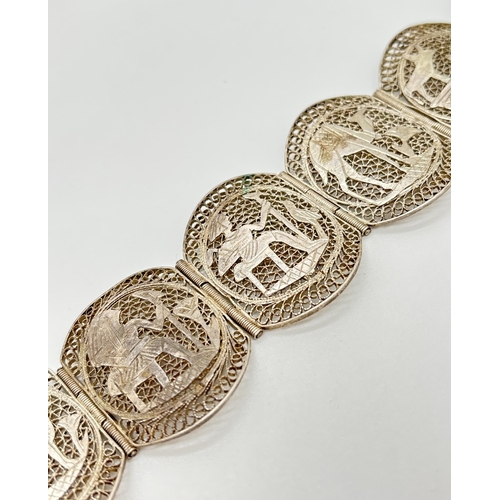 1070 - A vintage White metal filigree 6 panel bracelet decorated with Egyptian characters and scenes. Push ... 