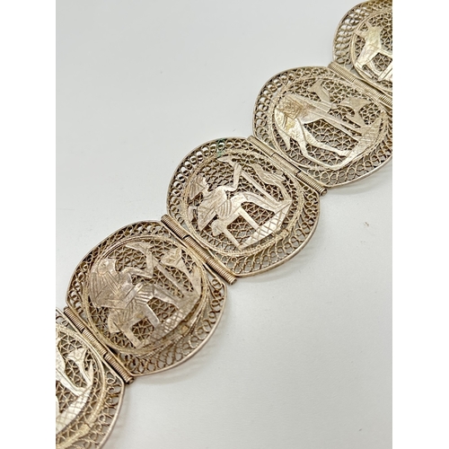 1070 - A vintage White metal filigree 6 panel bracelet decorated with Egyptian characters and scenes. Push ... 