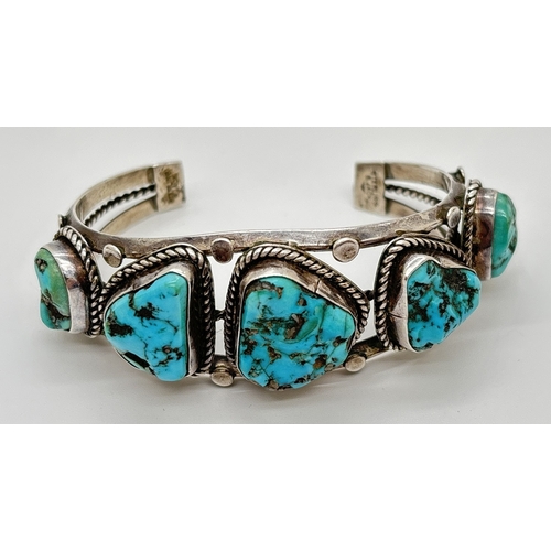 1082 - A Native American silver cuff bangle set with 5 pieces of natural blue turquoise with rope detail to... 