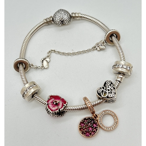 1096 - A boxed Pandora Moments Sparking Heart charm bracelet with pave set clasp, safety chain charm and 5 ... 