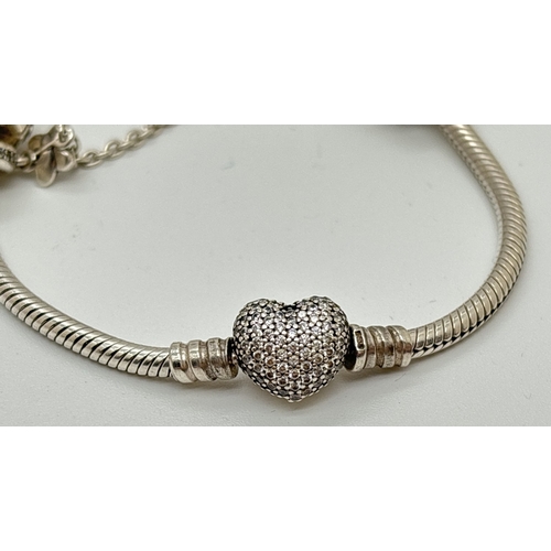 1096 - A boxed Pandora Moments Sparking Heart charm bracelet with pave set clasp, safety chain charm and 5 ... 