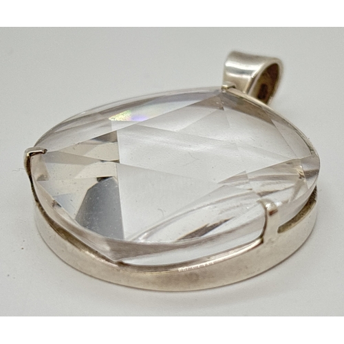 1099 - A large circular 6 pointed star polished clear quartz pendant with silver mount and bale. Silver mar... 