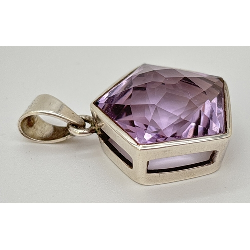 1100 - A pentagon star faceted amethyst pendant in silver mount. Silver mark to inside of bale. Approx. 4 x... 