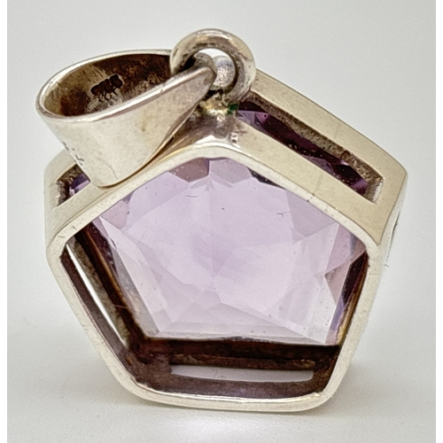 1100 - A pentagon star faceted amethyst pendant in silver mount. Silver mark to inside of bale. Approx. 4 x... 