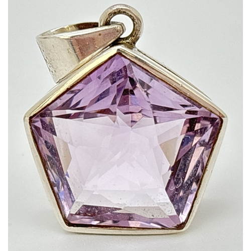 1100 - A pentagon star faceted amethyst pendant in silver mount. Silver mark to inside of bale. Approx. 4 x... 