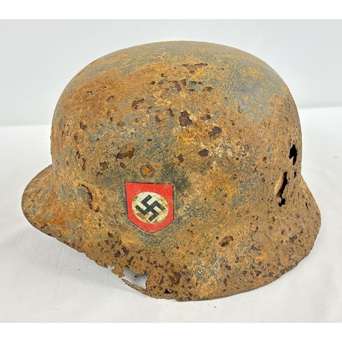 M35 German steel helmet bearing early version decals of the Waffen SS. With remains of apple green paint over-painted with field grey. Chin strap and liner headband present, leather cradle partially present. Vendor advises it was found in the positions of Waffen SS II Panzer Division “Das Reich” near Moscow.