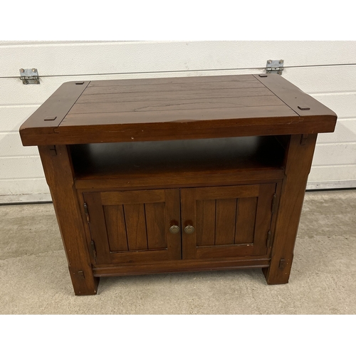 1464 - A heavy mango wood 'Zocalo' 2 door cabinet with metal knob handles and undershelf. Approx. 64cm tall... 