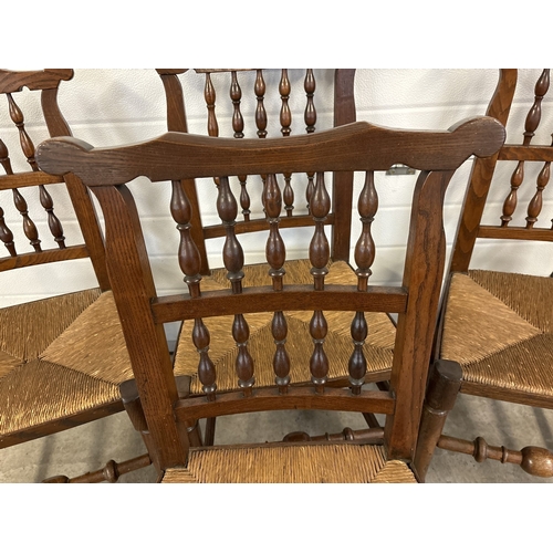 1468 - A set of 4 matching antique Lancashire spindle back chairs with rush seats and dark oak frames. With... 