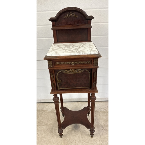 1469 - An antique French nightstand with marble lined pot cupboard and ornate bronzed metal moldings. With ... 