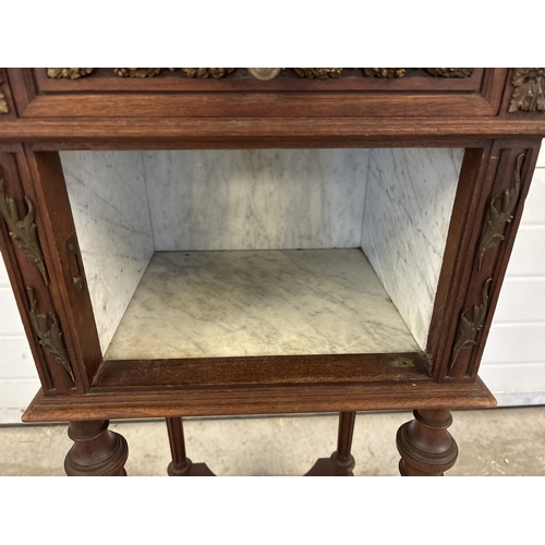 1469 - An antique French nightstand with marble lined pot cupboard and ornate bronzed metal moldings. With ... 