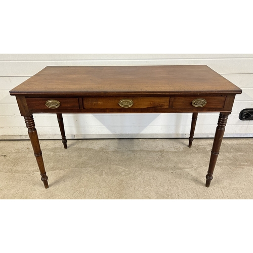 1470 - A Georgian dark wood 3 drawer side or writing table with turned legs. Brass drop handles (not origin... 