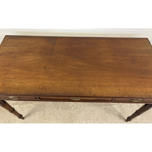 1470 - A Georgian dark wood 3 drawer side or writing table with turned legs. Brass drop handles (not origin... 