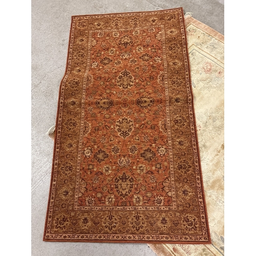 1474 - 2 modern rugs of floral design. Larger tassle ended salmon pink ground rug, approx. 185cm long x 125... 