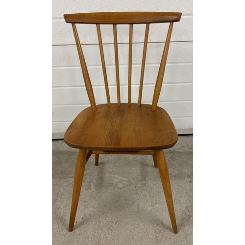 1478 - A vintage mid century Ercol light beech kitchen chair with splayed legs and curved spindle back. Sta... 