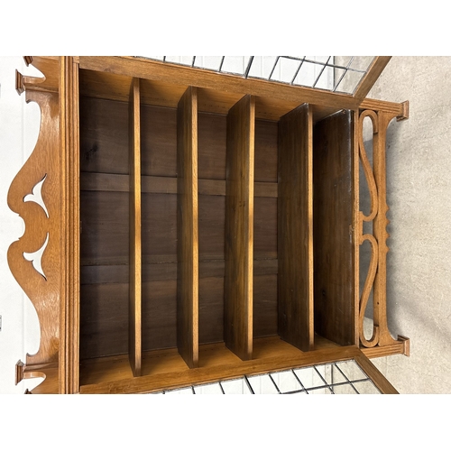 1479 - An early 20th century Art Deco light oak double bookcase with leaded glass doors and carved detail. ... 