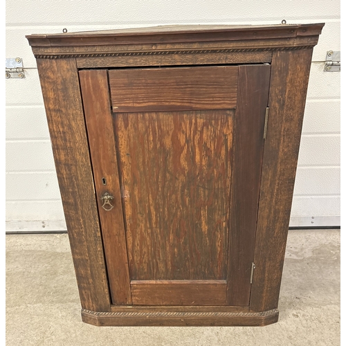 1486 - An antique dark wood wall hanging corner cupboard with interior shelf. Beaded molding to top & botto... 