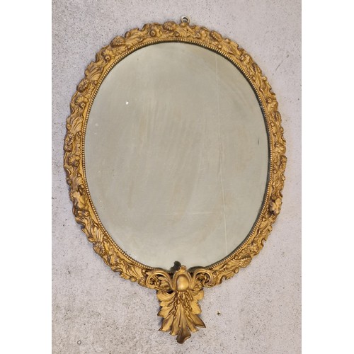 1487 - An antique Rococo style mirror with gilt cast iron frame of floral design and candle holders modelle... 