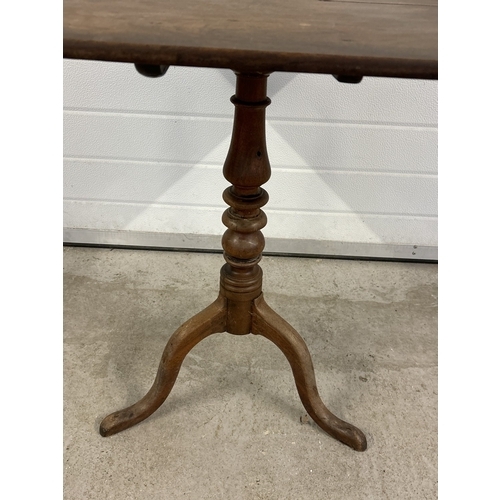 1485 - An antique walnut tilt top table with turned pedestal column and raised on tripod feet. Square shape... 