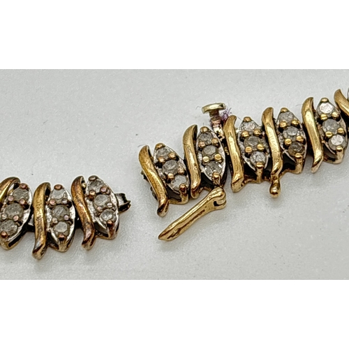 1015 - A 9ct gold and diamond 8 inch bracelet in need of repair. Each link comprises S design yellow gold a... 