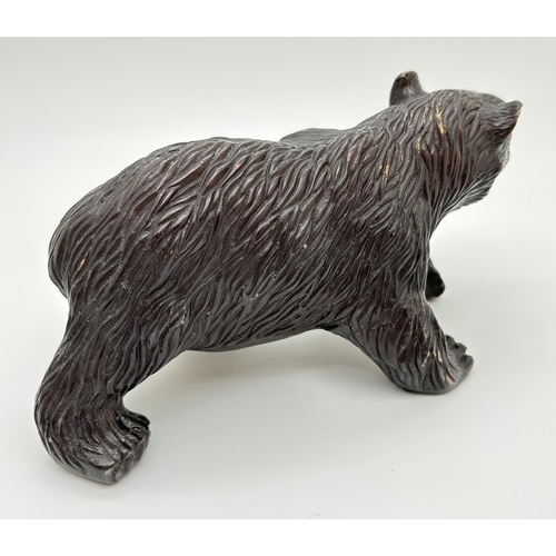 1197 - A hollow bronze figure modelled as a bear. Approx. 10cm tall x 21cm long.