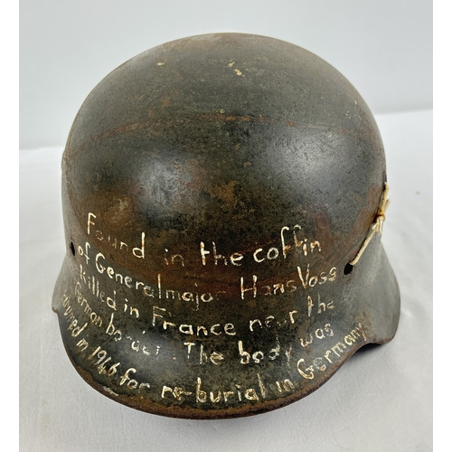 1213 - M40 German steel helmet shell bearing later painted inscription to effect it was recovered from the ... 