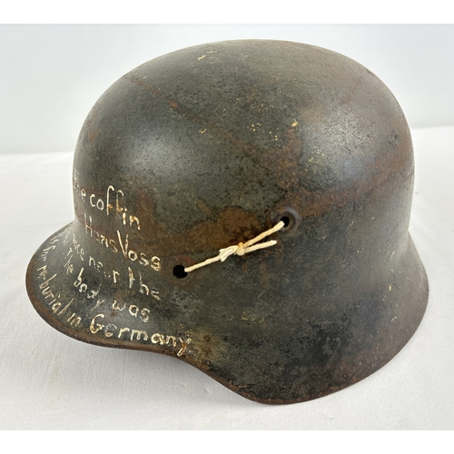 1213 - M40 German steel helmet shell bearing later painted inscription to effect it was recovered from the ... 