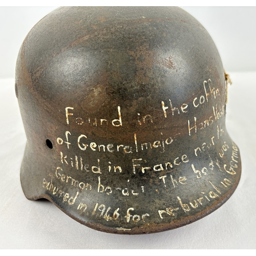 1213 - M40 German steel helmet shell bearing later painted inscription to effect it was recovered from the ... 