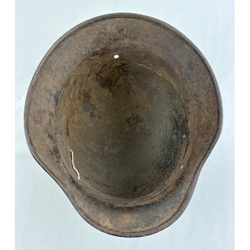 1213 - M40 German steel helmet shell bearing later painted inscription to effect it was recovered from the ... 