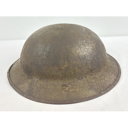 1216 - British-made WWI War Office Pattern steel helmet used by the US Army 1917-1918, stamped FS157. Beari... 