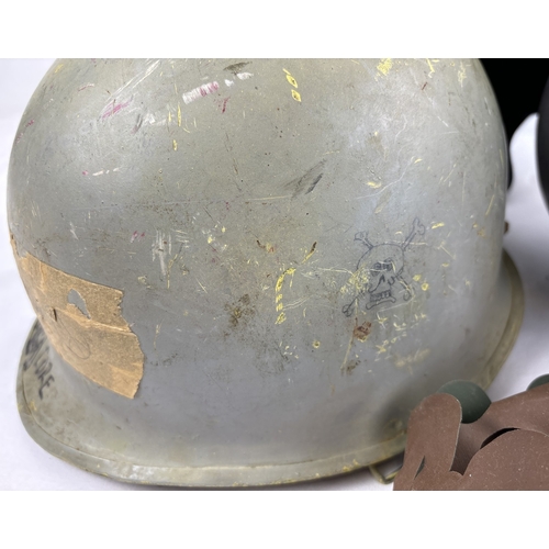 1219 - 3 post WWII helmets. A US Navy M1 steel helmet complete with plastic liner dated 1972. The helmet bo... 