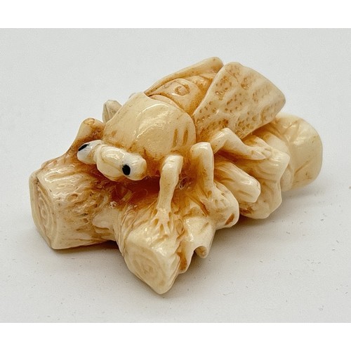 1283 - A signed Chinese netsuke modelled as a flying insect resting on a branch, possibly bone. Engraved si... 